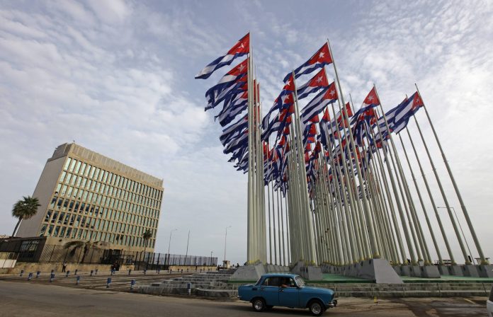 File picture shows a car driving past the building of the the U.S. diplomatic mission in Cuba, The U.S. Interests Section, (USINT), in Havana